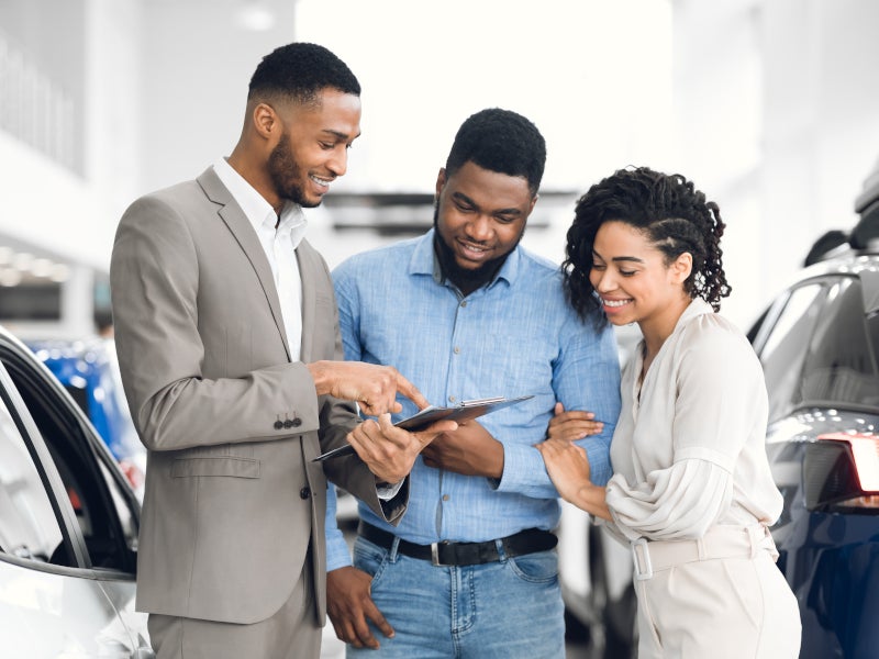 Couple talking to a dealership employee